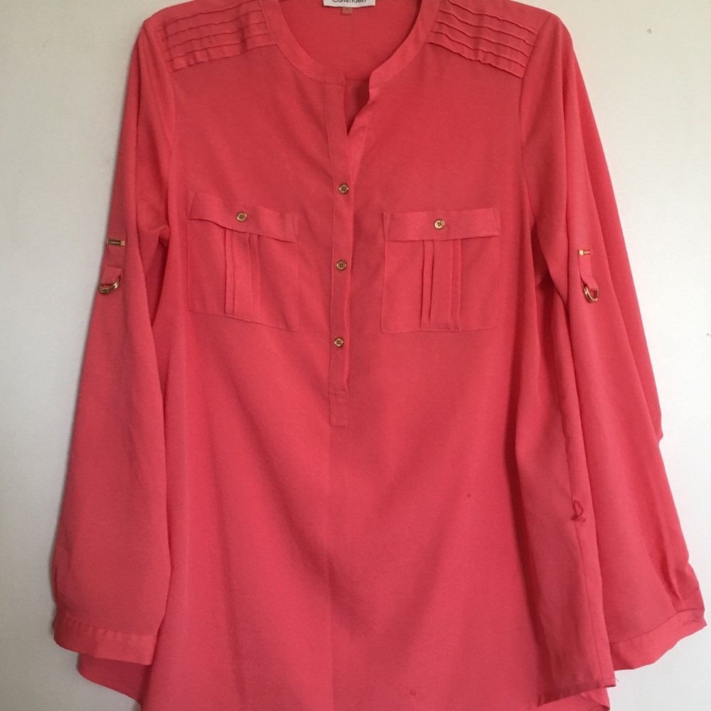 Salmon colored Calvin Klein shirt with gold detail